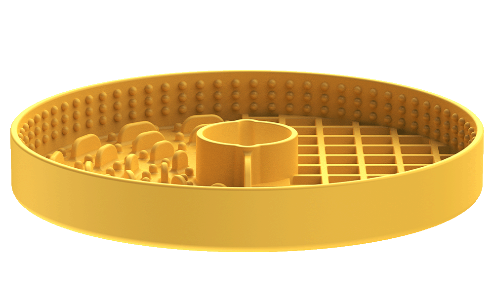 A yellow, round plastic object with a perforated grid on one half and a textured surface on the other, featuring a central cylindrical protrusion. This innovative puzzle feeder keeps pets entertained and engaged during mealtime.