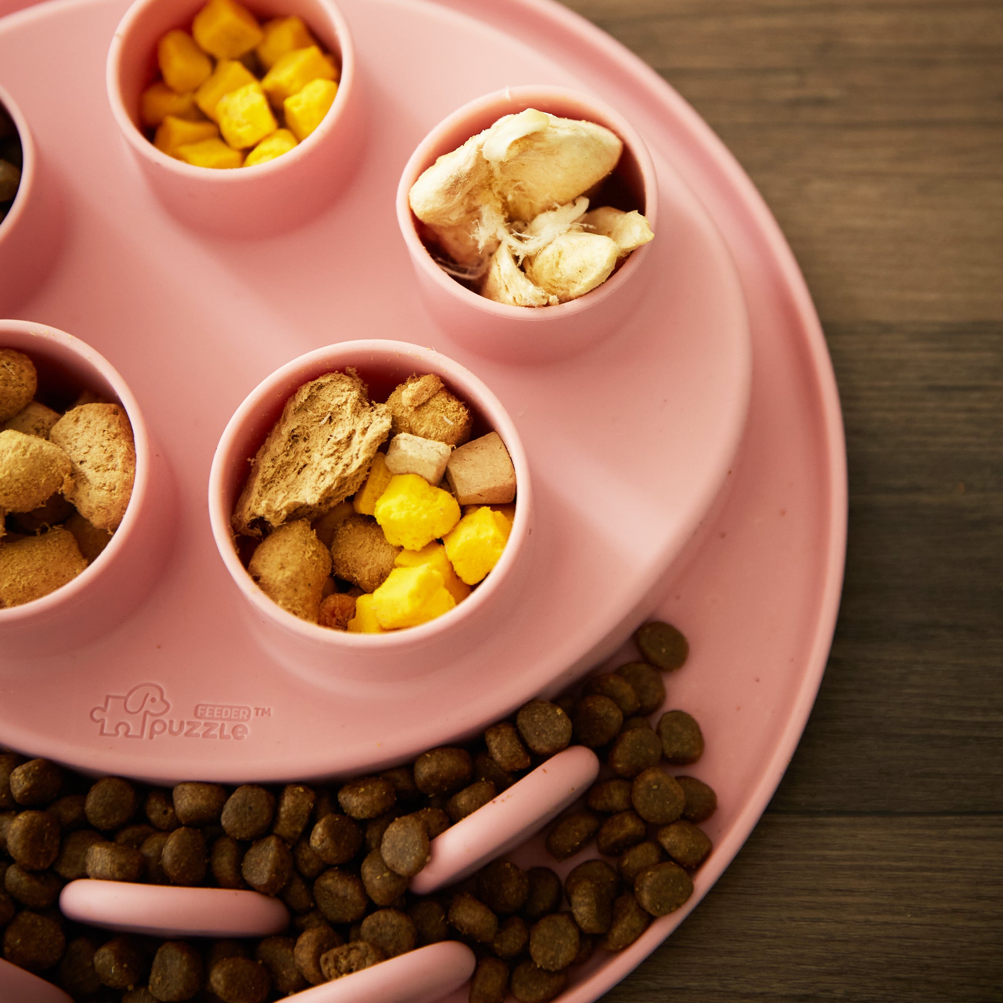 Introducing the Puzzle Digger - For Cat Hunting Instinct (Coral-Pink) by Puzzle Feeder™. This biomimetic design features compartments filled with dry kibble, freeze-dried chicken, corn, and other treats to awaken your pet's natural hunting instincts for interactive playtime.
