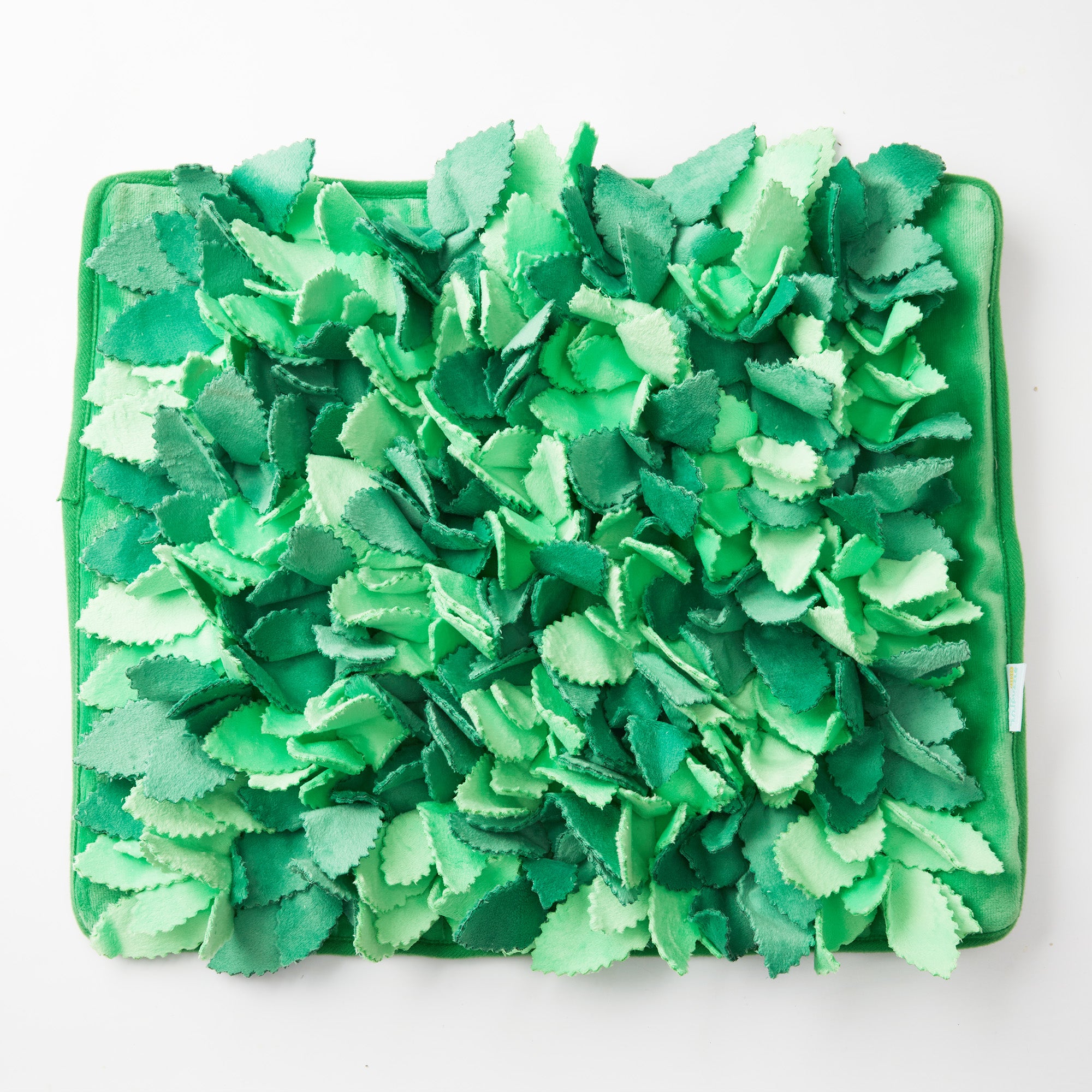 Introducing the Dog Puzzle Grass Sniffle Mat - Hide, Seek, Feast! by Puzzle Feeder™, a square mat covered with layered green fabric pieces resembling leaves that offers sensory stimulation similar to realistic grass.