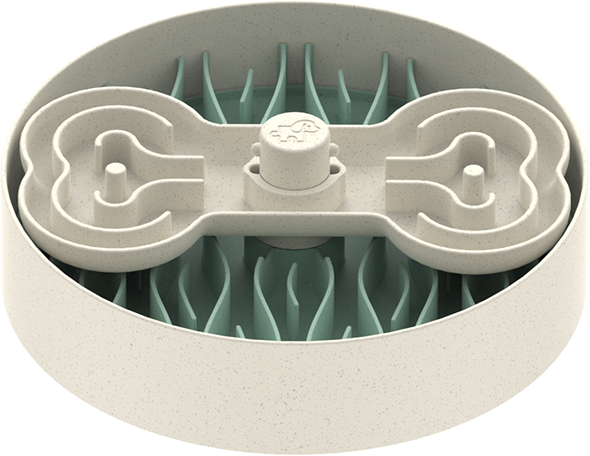 A round, beige dog food bowl with a bone-shaped maze and green, leaf-like obstacles serves as an engaging puzzle feeder designed to slow down eating.