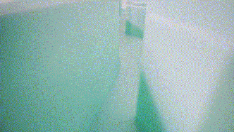 Close-up of abstract, light green and white geometric shapes. The image, reminiscent of a puzzle, has a soft, blurred effect creating an ethereal atmosphere.