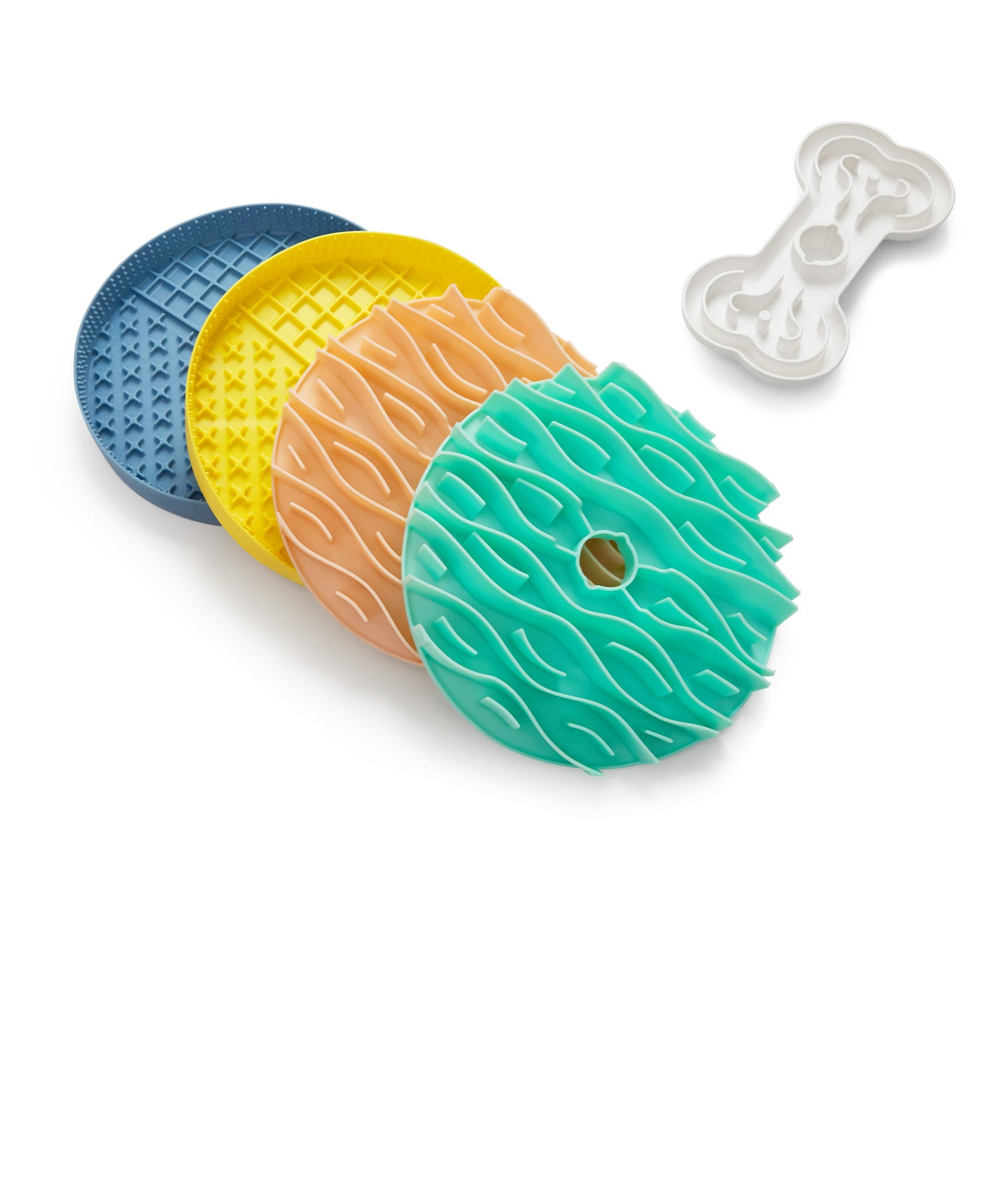 Colorful textured dog treat mats along with a bone-shaped mold.