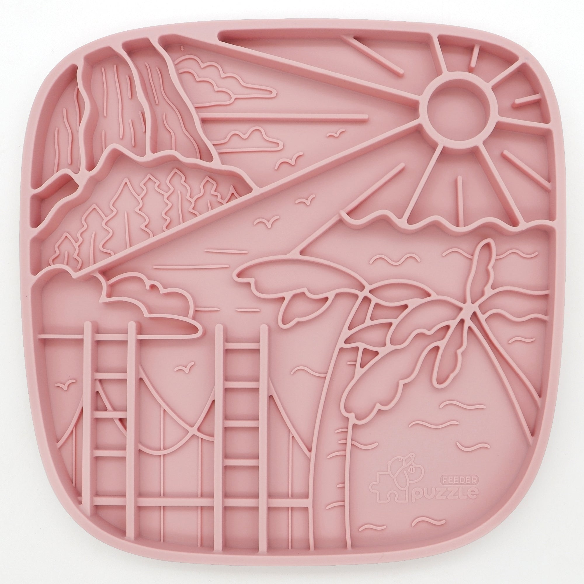 The Puzzle Feeder™ California Themed Lick Mat is a pink silicone placemat with a raised beach scene design including the sun, palm trees, mountains, and ocean waves. It doubles as a slow feeding mat to encourage healthy digestion for pets in style.