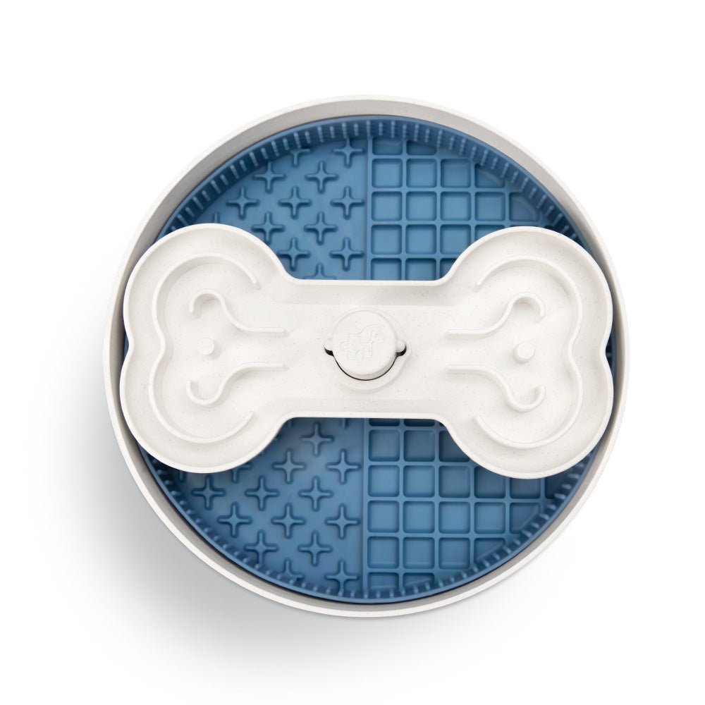 The Puzzle Feeder™ Puzzle Licker Maze - Triple Textures, Triple Fun (Blue) is a dog food bowl that features a bone-shaped slow feeder insert designed to enhance your dog's dental health.