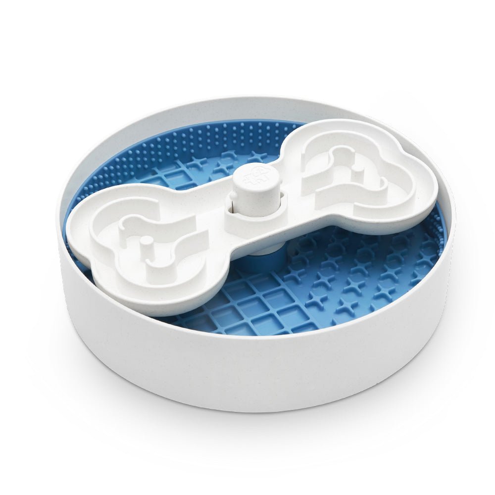 Introducing the Puzzle Licker Maze - Triple Textures, Triple Fun (Blue) by Puzzle Feeder™. This engaging pet feeding puzzle comes with a white bone-shaped spinner on top, ideal for dispensing treats. As a slow feeder dog bowl, it not only provides fun and entertainment but also supports canine dental health by encouraging prolonged chewing and eating times.