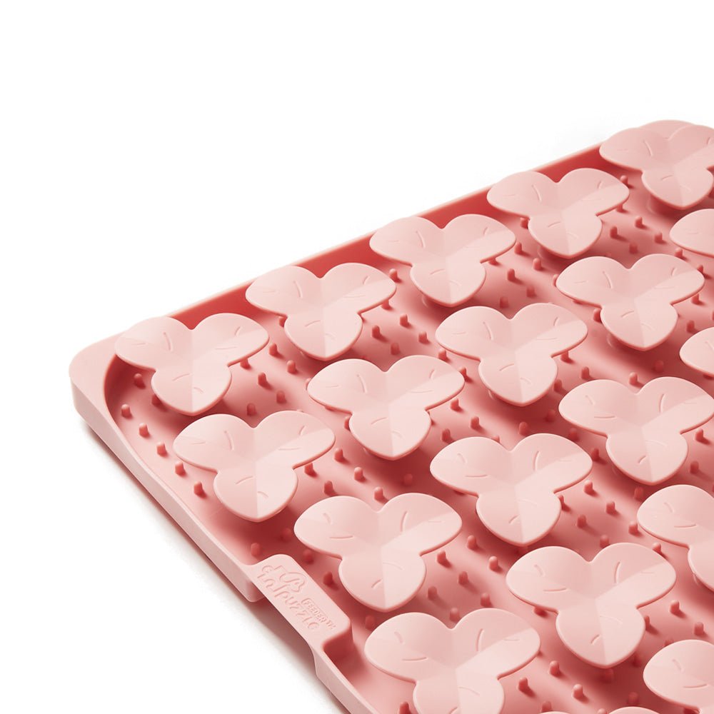 This pink slow feeding mat from Puzzle Feeder™ features dog puzzle molds crafted from non-toxic materials for safe use.