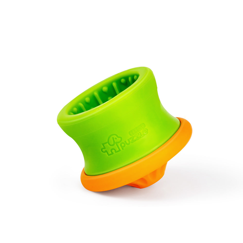 Made from eco-friendly material, the Puzzle Feeder™ Dog Puzzle Tumbler M is a green and orange rubber toy with a textured interior, ideal for enriching mealtime for small to medium breeds.