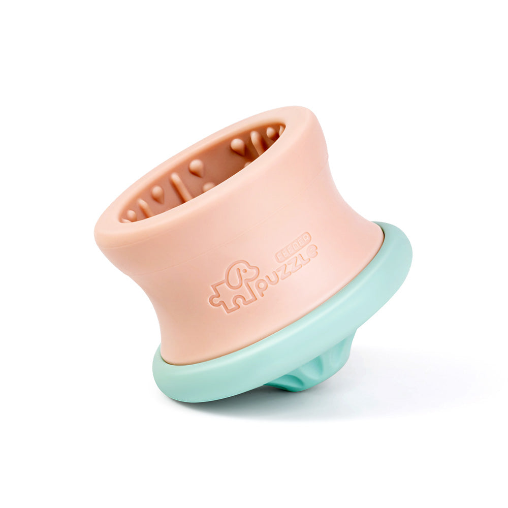 Introducing the Dog Puzzle Tumbler by Puzzle Feeder™: an enrichment toy and puzzle feeder for large and extra-large pups, featuring a peach barrel-like shape with a blue textured base, expertly crafted from eco-friendly OBP material for optimal canine mental stimulation and mealtime enjoyment.