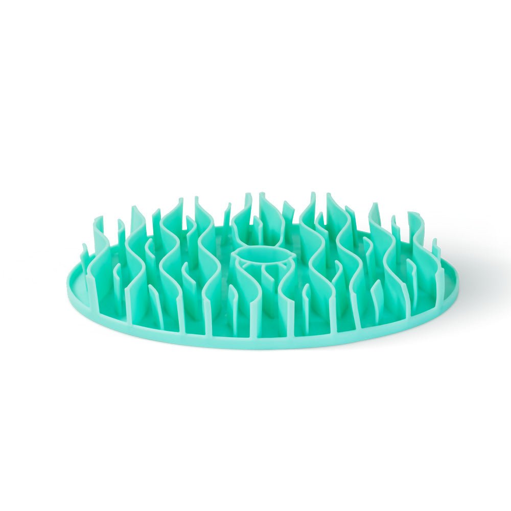 Introducing the Dog Slowing Mat Accessory by Puzzle Feeder™, a round teal plastic slow feeder designed with raised wave-like ridges to challenge your pet during mealtime.